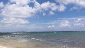 A beach with clear skies and waves.