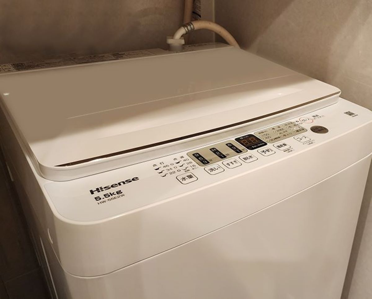 A white washing machine with a control panel displaying various settings and buttons.