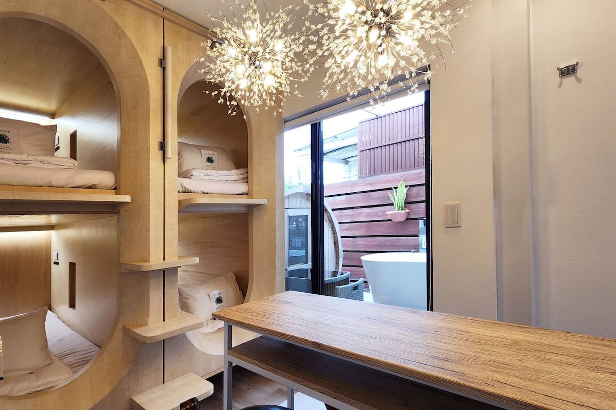 A hotel room with a wooden vanity, a large mirror, and a chandelier.