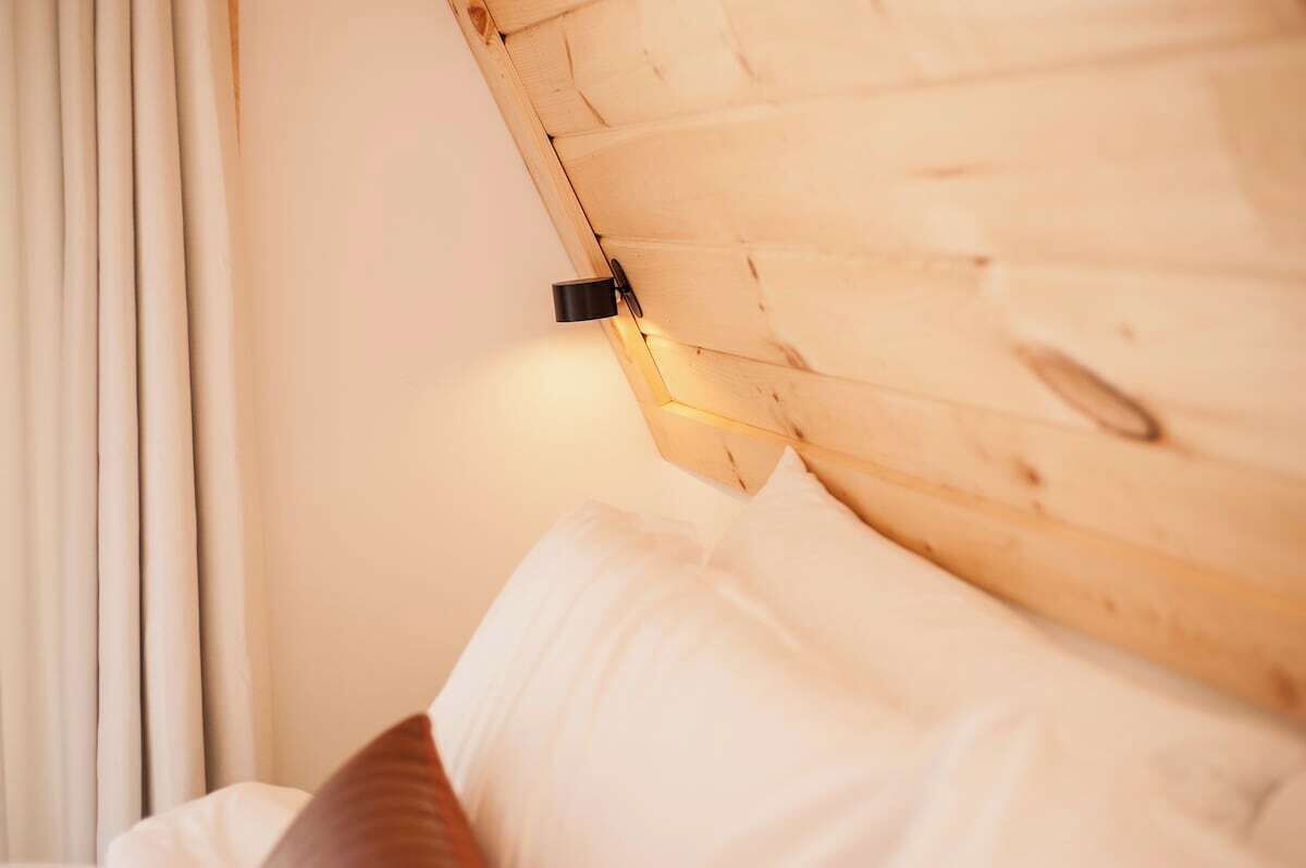 A wooden headboard with a built-in light fixture.