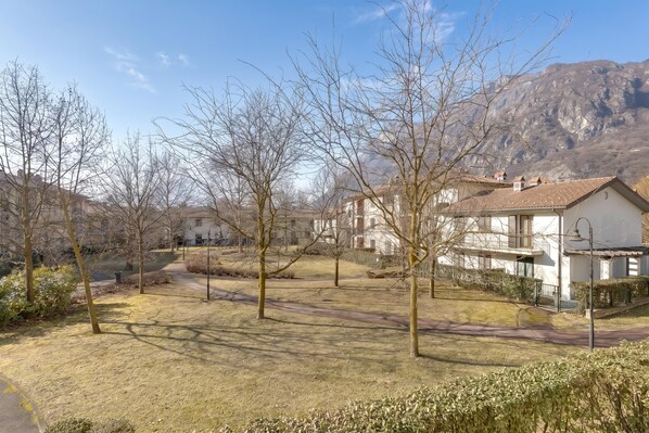 A residential area with houses, trees, and a mountain in the background.