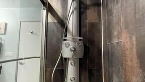 A modern bathroom with a built-in shower and a glass-enclosed shower area. - Charming 1 Bedroom Industrial Loft w/ Dedicated Parking (Portland)
