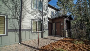 A two-story building with a brick entrance and a small porch area. - Walk to Ski, Large 2 Bed 2 Bath Near Lifts 459 (Mammoth Lakes)