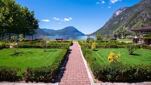 A pathway leading to a lake with mountains in the background.