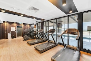 A gym with treadmills, a stationary bike, and a stair climber.