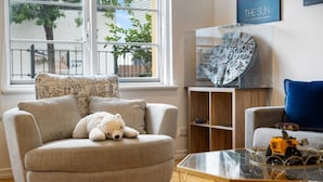 A living room with a grey sofa, a glass coffee table, and a teddy bear. - Lego-Aerospace/Free Parking/CBD/Chinatown (Adelaide)