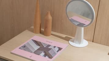 A wooden table with a magazine titled "SPACE" and two wooden vases.