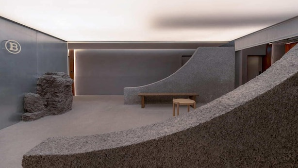 A modern interior with a curved seating area, a small table, and a bench. - Siheung Brown Dot Jeongwang (Siheung)