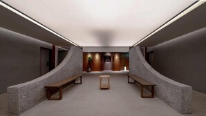 A modern hallway with a central seating area, benches, and a reception desk. - Siheung Brown Dot Jeongwang (Siheung)