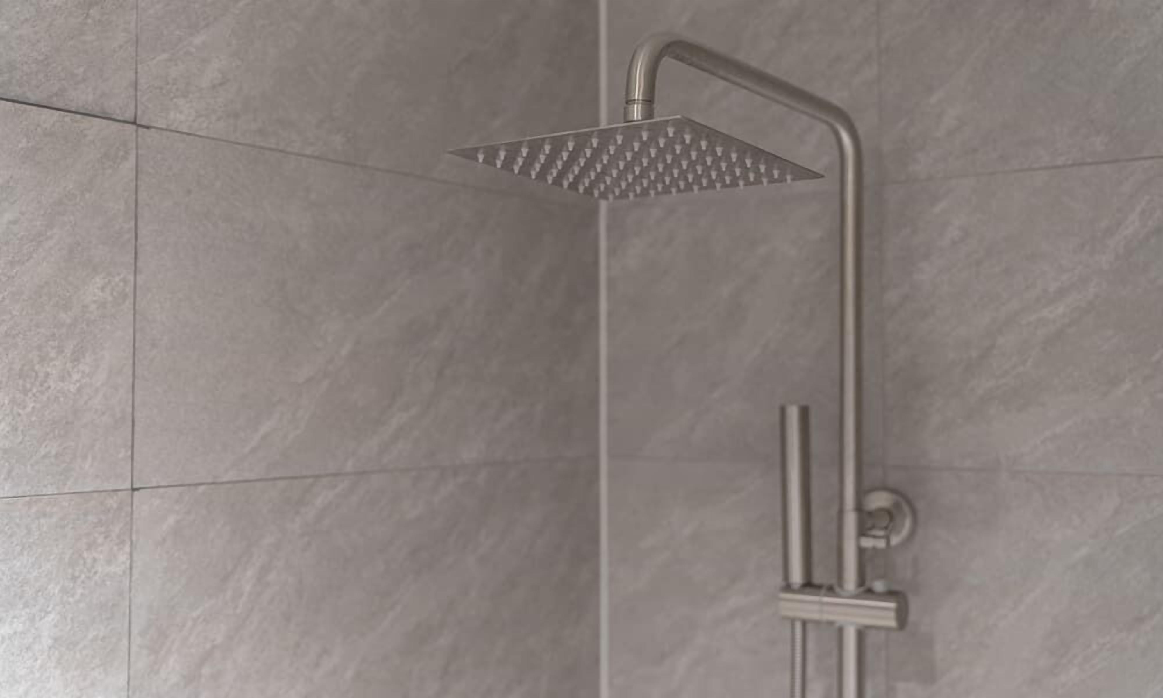 A shower with a square head and a vertical handle.