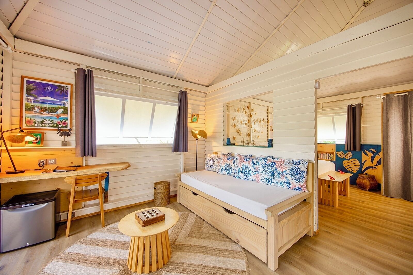 A cozy room with a wooden bed, a desk, and a small table.