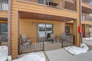 A building with a covered outdoor seating area, a fire escape, and a fire hydrant. - Steph's Waterfront Retreat (Wisconsin Dells)
