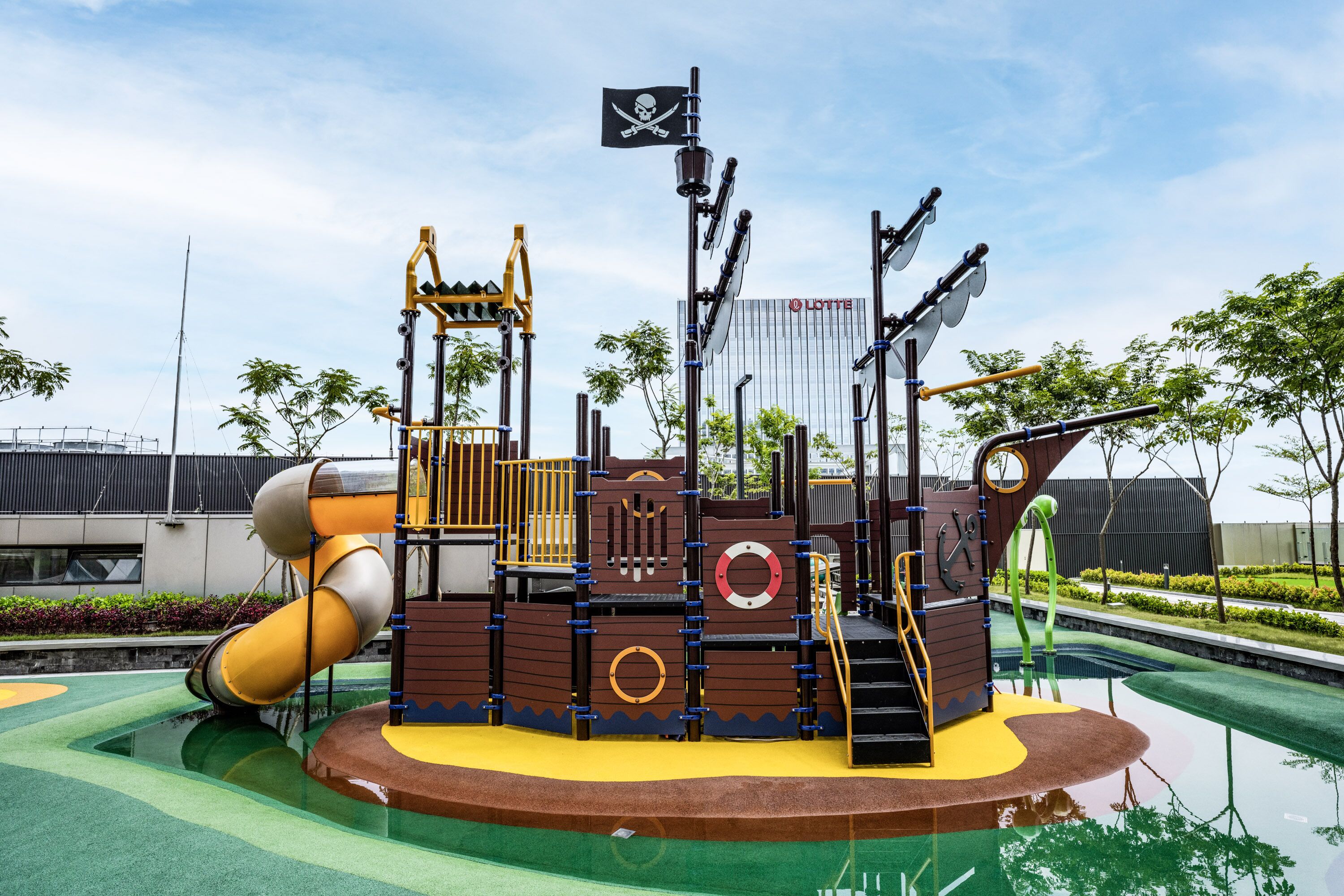 A playground with a pirate ship theme, including slides and climbing structures.