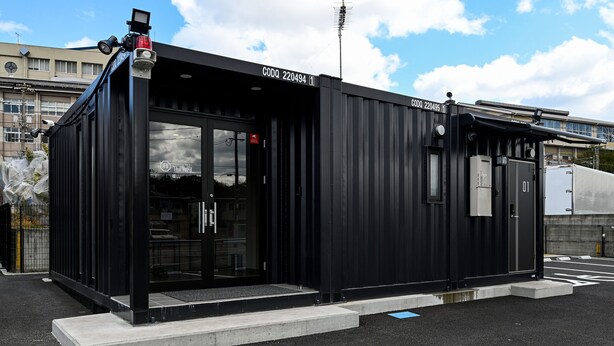 A black metal building with a glass door, a small window, and a metal roof. - HOTEL R9 The Yard Fukuyama (Fukuyama)