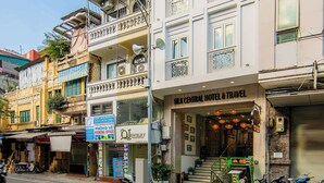 A multi-story hotel with balconies, a visible entrance, and a sign for a jewelry store. - THE SILK BOUTIQUE HOTEL & SPA (Hanoi)