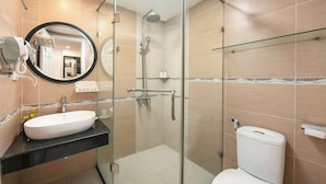 A modern bathroom with a glass-enclosed shower, a white sink, and a toilet. - THE SILK BOUTIQUE HOTEL & SPA (Hanoi)
