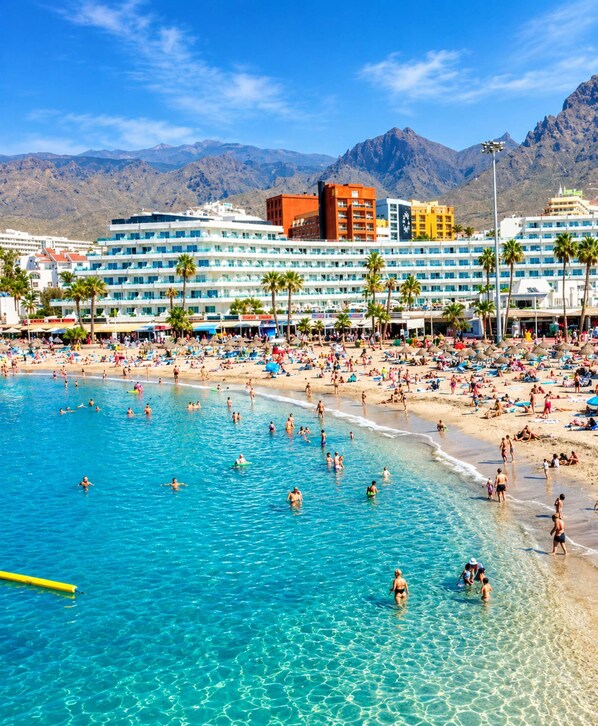 A coastal hotel with multiple floors, a pool, and beach access. - Orlando Pool View and cozy terrace (Costa Adeje)