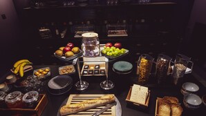A buffet setup with various food items and utensils. - Naâd Hotel (Sarlat-la-Canéda)