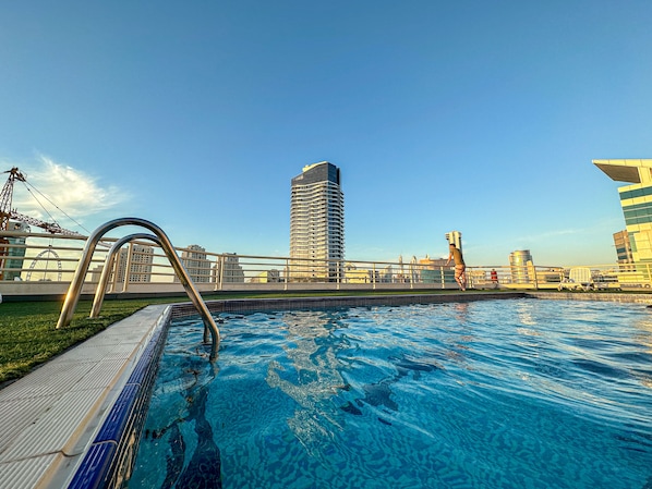 Enjoy unobstructed views of the city from our rooftop pool, surrounded by a glass floor and metal railing.