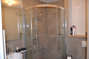 Shower, hair dryer, towels, toilet paper