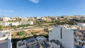 A cityscape with buildings, roads, and a construction site. - Stylish 2BR Meridian suite in central St Julians (San Ġiljan)