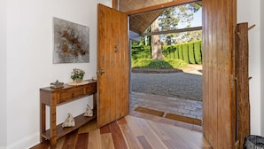 A wooden door leading to a garden with a gravel path and neatly trimmed hedges. - Hollydale, Burradoo, Southern Highlands (Burradoo)