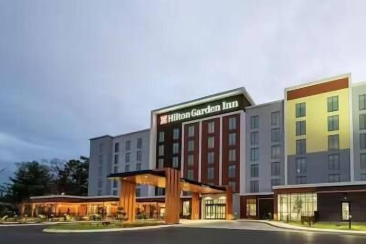 A multi-story hotel with a prominent entrance and a sign reading 'Hilton Garden Inn.'