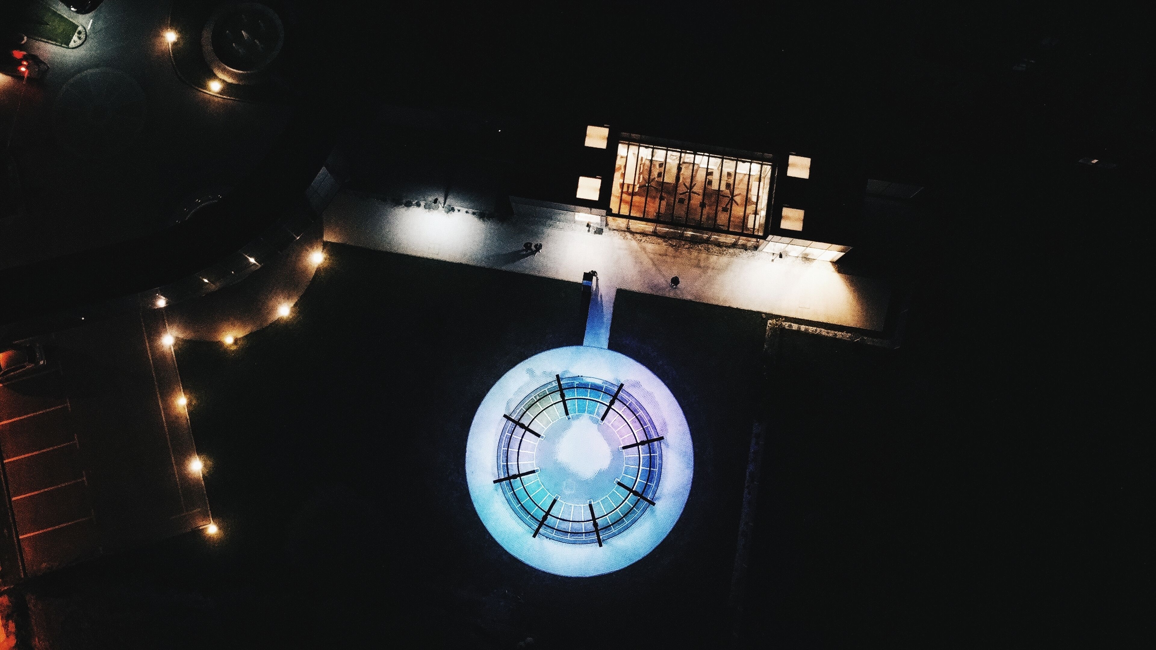 A circular structure with a central light source, surrounded by a railing.