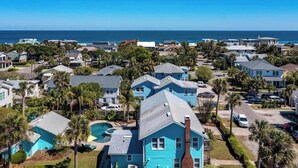 A residential area with houses, a swimming pool, and a view of the ocean.