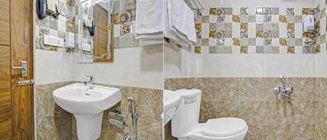 A bathroom with a sink, toilet, and shower.
