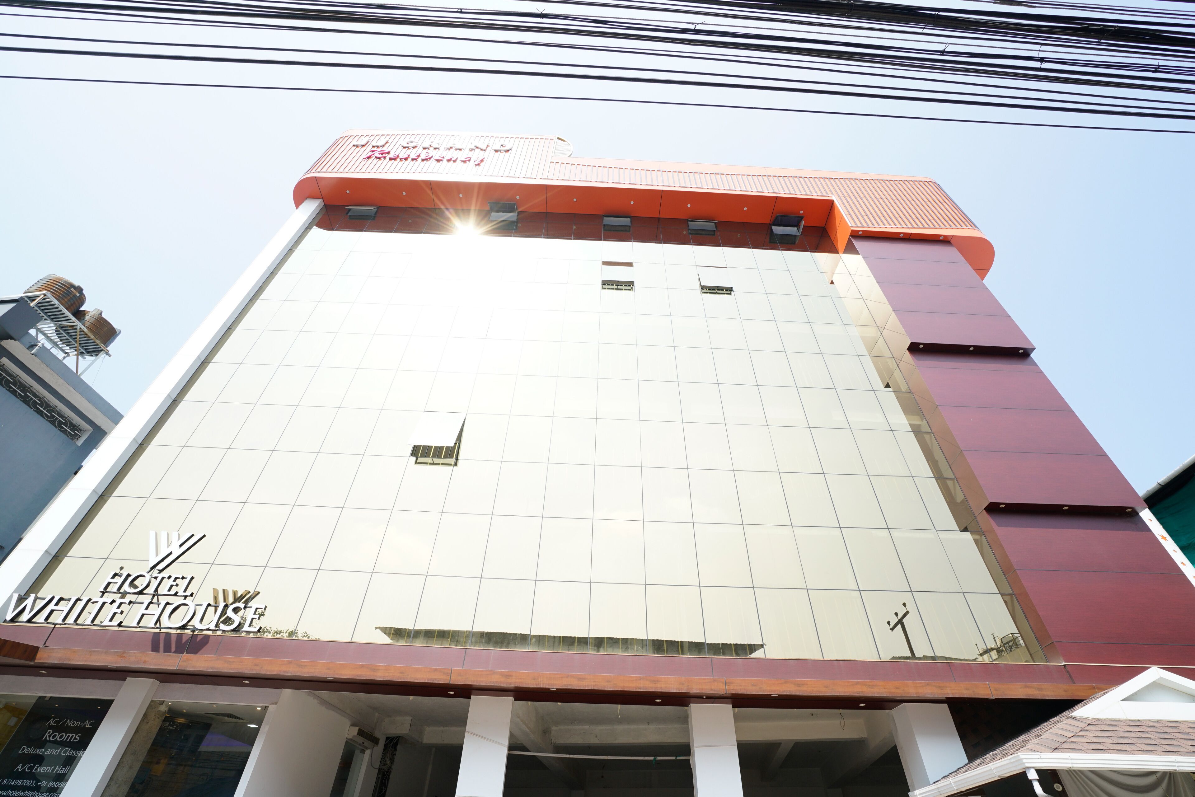 A hotel with a modern facade, large windows, and a prominent sign.