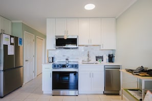 Fully equipped kitchen with oven, microwave, and dishwasher.