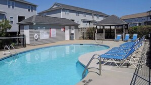 A swimming pool with a no diving sign, lounge chairs, and a lifeguard station. - Catchin' A Dream - 3BR Turtle Cove Unit - Sunset Views, Comm. Pool & Beach (Surf City)