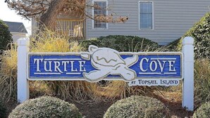 A sign for Turtle Cove at Topsail Island with a turtle graphic. - Catchin' A Dream - 3BR Turtle Cove Unit - Sunset Views, Comm. Pool & Beach (Surf City)