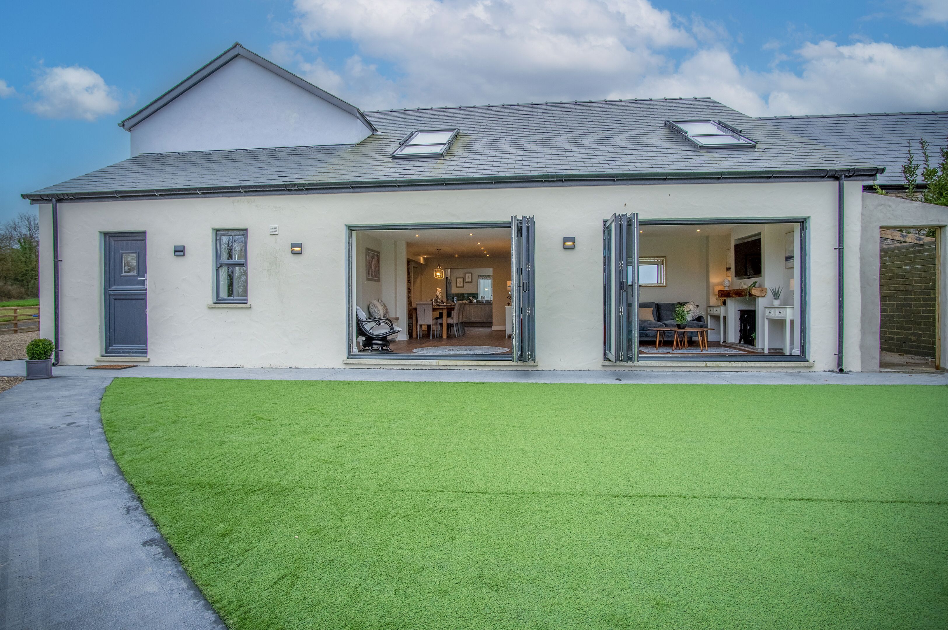 A modern house with a large open-plan kitchen, a dining area, and a living room.