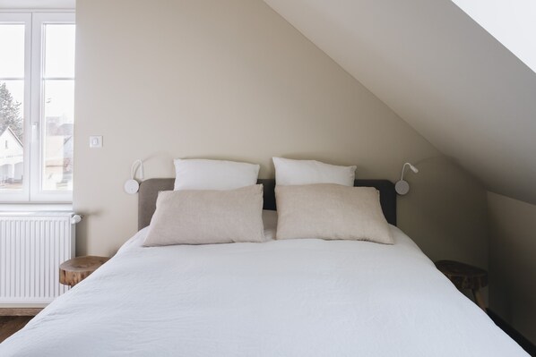 A bedroom with a bed, two bedside tables, and a window. - 10 min walk from town center: large town house with small garden (Colmar)