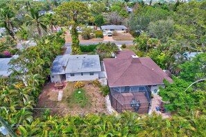 A residential area with houses, a fenced yard, and a clear sky. - Subtropical Oasis -Naples, Fl Retreat (Naples)