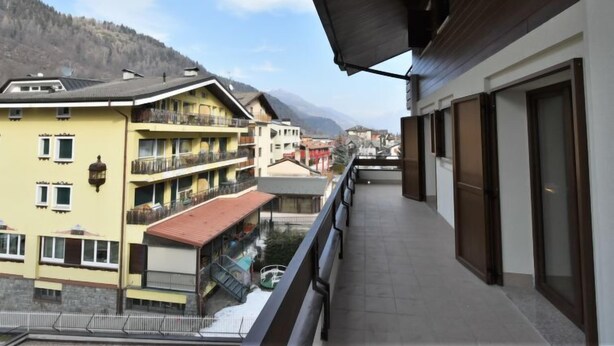 A balcony with a view of a mountain and buildings. - Stefania by Interhome (Aprica)