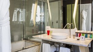 A modern bathroom with a glass shower enclosure, a white sink, and a mirror with a towel rack. - Autograph Collection Palazzo Matteotti, The Dedica Anthology (Milan)
