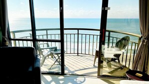 A balcony with a view of the sea, furnished with chairs and a table. - Penthouse Suite/ Oceanfront/Prime location (Myrtle Beach)
