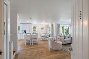 A modern interior with a dining area, kitchen, and living space.