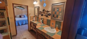 A bathroom with a checkered tile backsplash, a sink, and a mirror. - Oceanview Getaway, Large Beach House w/ Pool, Hot Tub & 2 Kitchens (Loreto)