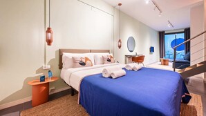 A modern hotel room with a large bed, a desk, and a view of the outside. - Sweett | Girona B1 - Two Bedroom Apartment, Sleeps 5 (Barcelona)