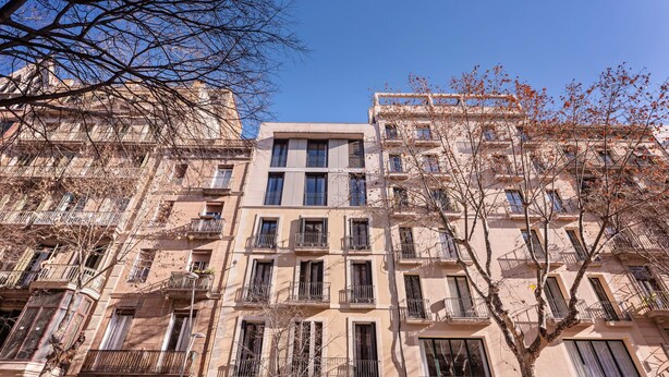A multi-story building with balconies and a clear sky. - Sweett | Girona B1 - Two Bedroom Apartment, Sleeps 5 (Barcelona)