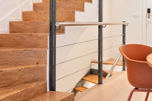 A staircase with a metal handrail and wooden steps.