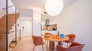 A modern kitchen with a dining area. - Sweett | Girona B1 - Two Bedroom Apartment, Sleeps 5 (Barcelona)