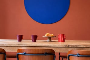 A wooden table with a pastry display and red cups. - Sweett | Girona B2 - Four Bedroom Apartment, Sleeps 10 (Barcelona)