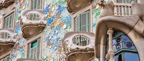 A building with distinctive Art Nouveau architecture, featuring ornate balconies and a mosaic-tiled facade.