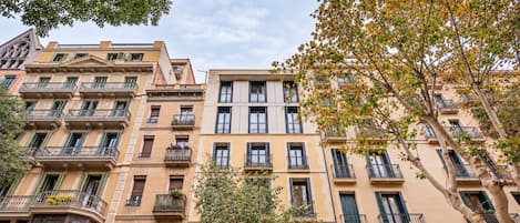 A multi-story building with balconies and windows.