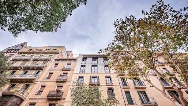A multi-story building with balconies and windows, surrounded by trees. - Sweett | Girona 501 - Three Bedroom Apartment, Sleeps 7 (Barcelona)